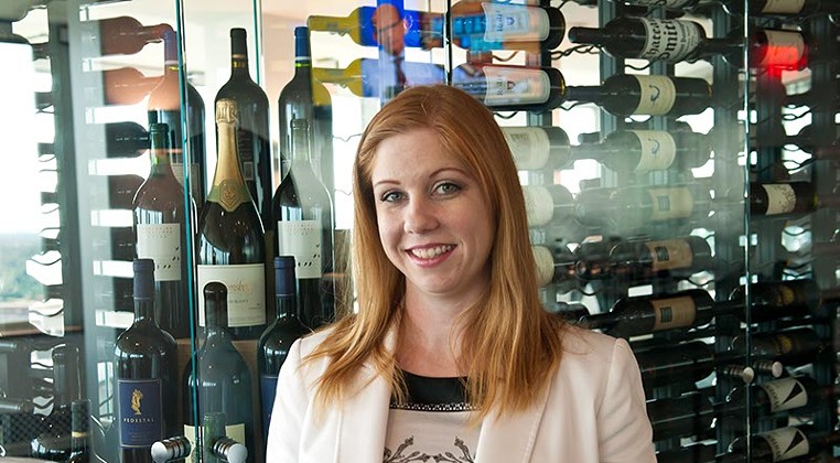 The George's female sommelier Mindie Magers with its extensive wine collection. (Mark Hancock)