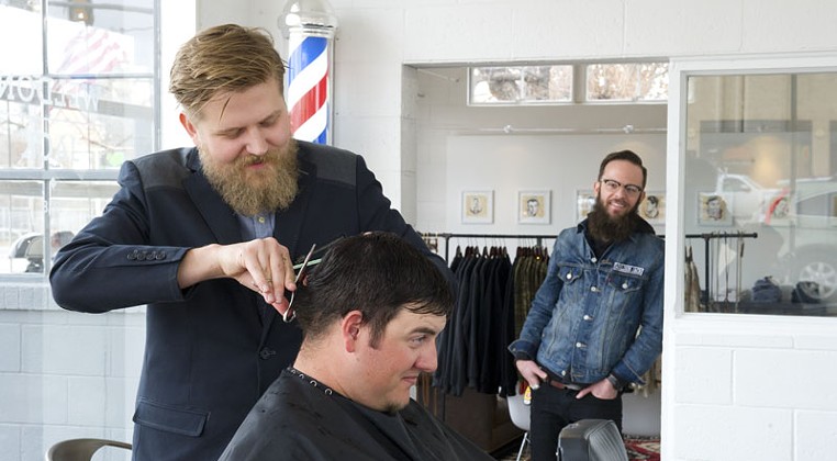 Travis Whitmire has his hair cut by Jake Phelps as Jerrod Smith looks on at Weldon Jack. Photo/Shannon Cornman