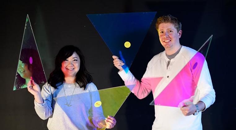 Anh Weber and Adam Edge with dichroic film on acrylic, used to create a faceted fabric, at HSE Architects. (Garett Fisbeck)