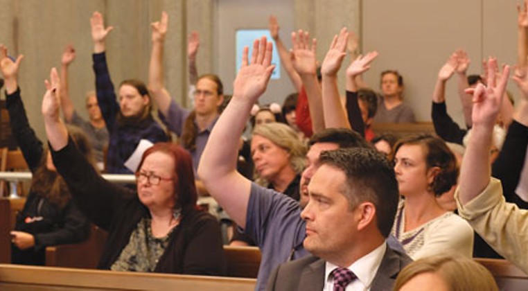 Audience members raise their hands in support of preserving the Donnay Building when asked by Planning Commissioner Janis Powers to do so. (Megan Nance)