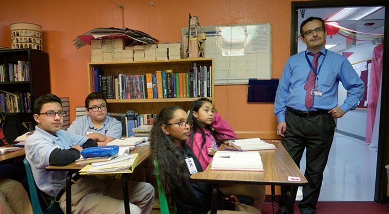 Superintendent Umit Alpasian observes a seventh-grade English class at Dove Science Academy, which was one of six Oklahoma schools named a National Blue Ribbon School in 2017. (Photo Garett Fisbeck)