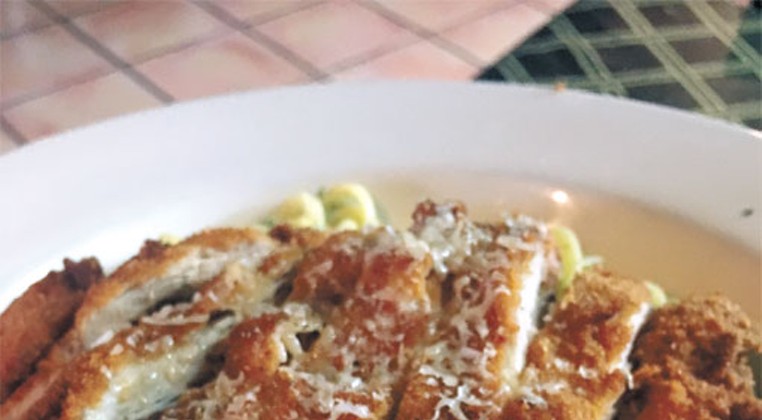 A lunch portion of linguine with pesto cream topped with a fried chicken cutlet | Photo Jacob Threadgill