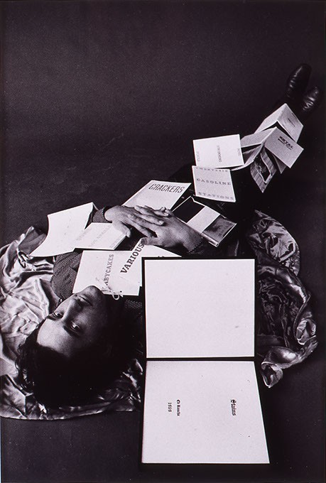 "Ed Ruscha Covered with Twelve of his Books" by Jerry McMillan (Image Fred Jones Jr. Museum of Art / provided)