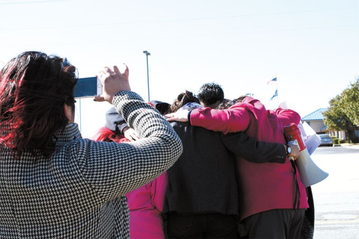 Members of Dream Act Oklahoma engage in a group hug with a Norman family two days after their father was detained by immigration officers in late October. | Photo Laura Eastes