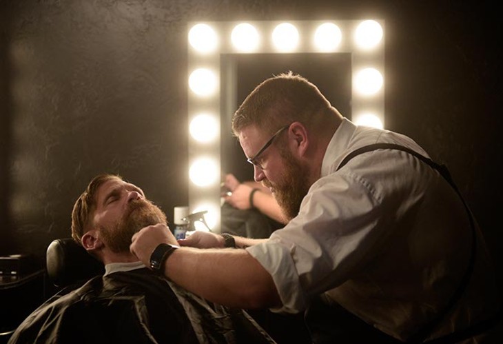 Joel Robinson trims Ben Grunewald's beard at the newly opened Manscape & Massage Clinic. (Garett Fisbeck)