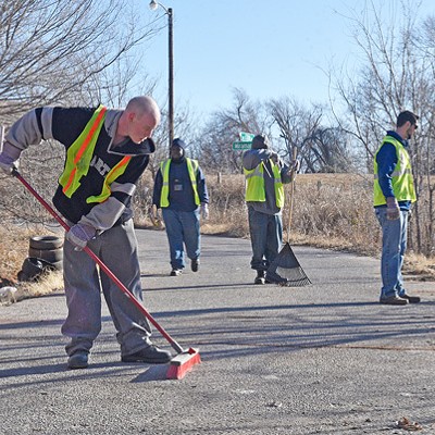 Participants in the Center for Employment Opportunities remove debris from an illegal dumpsite in northeast Oklahoma City. (Photo Laura Eastes)